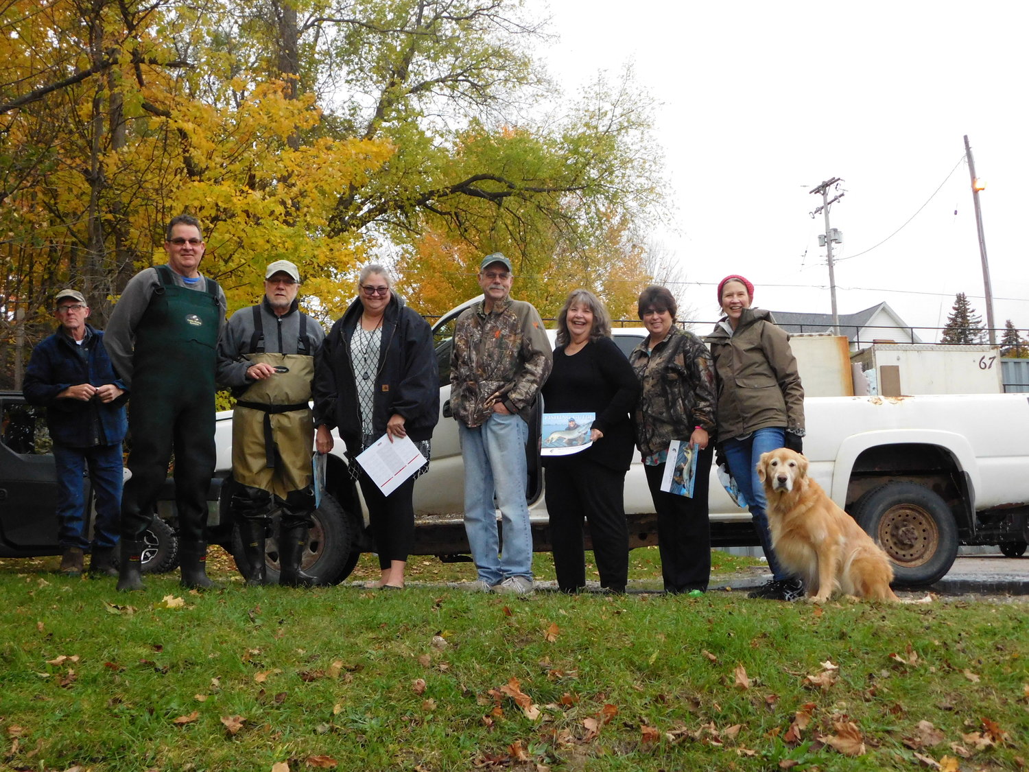 Participants in the blustery Oct. 25 Budd Lake fish planting gather for a group shot. They include, from left, Don Sisson of Imlay City Fish Farm; Ernie Teall and Jerry McBrien of the Budd Lake Association; Tracy Wheeler-Clay, City of Harrison; Ken Koehler, resident; Connie Cauchi, Harrison City Council member; Kathy Maharas, City of Harrison utilities clerk; and Terri Koehler, also BLA.